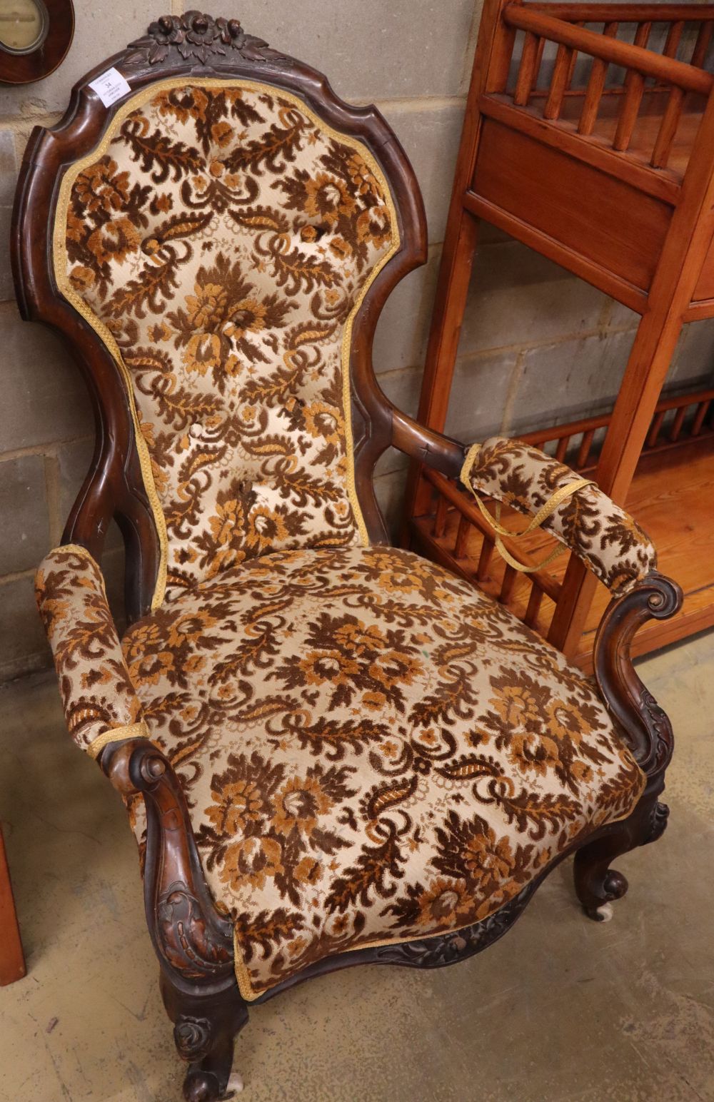 A Victorian rosewood spoon back open armchair